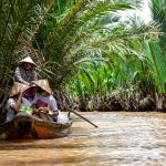 Destinations Explore the vibrant scenery on a traditional boat ride through the Mekong Delta's palm-lined waterways.